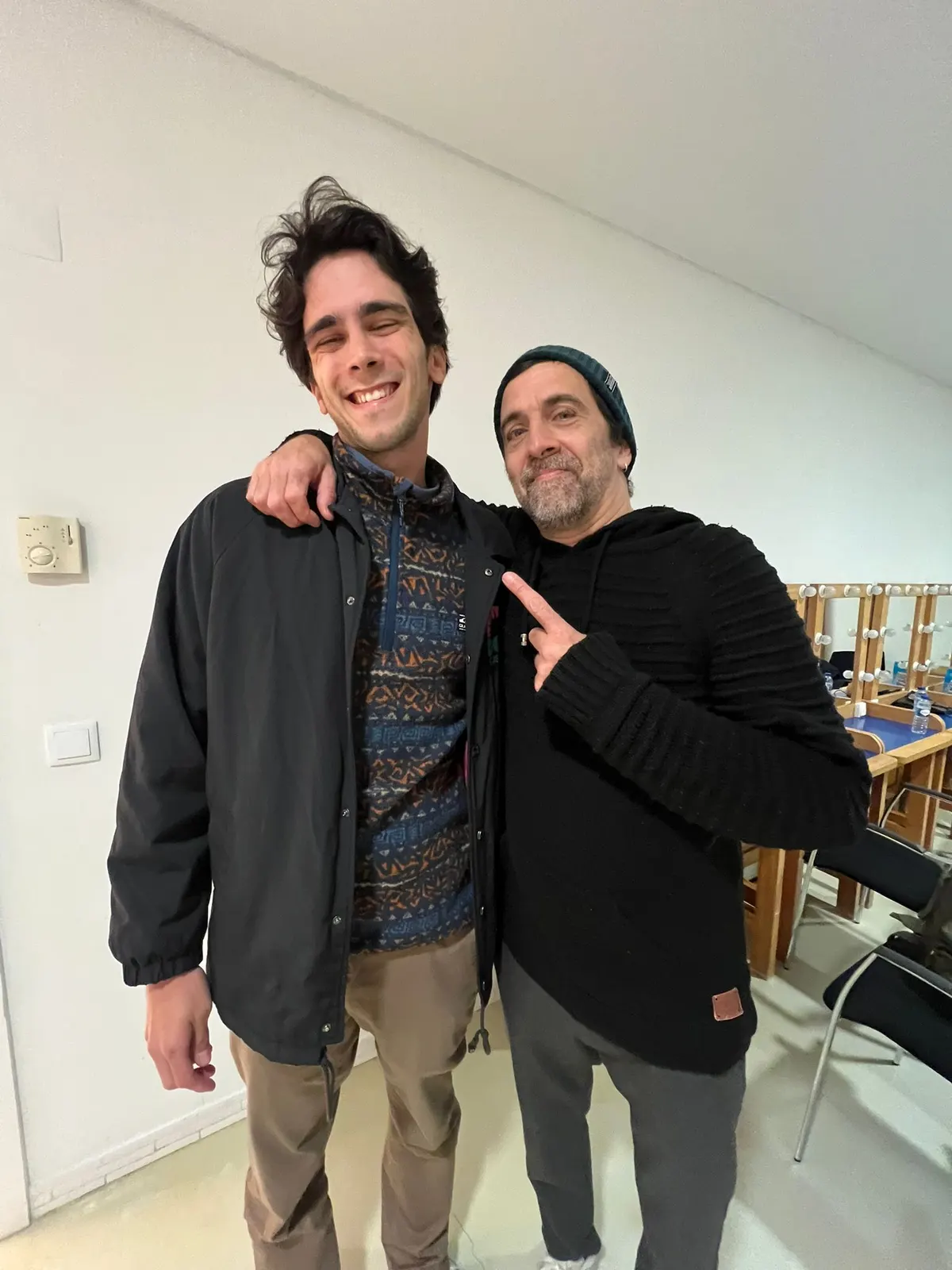 Two Sadhäna band members embracing backstage before a show