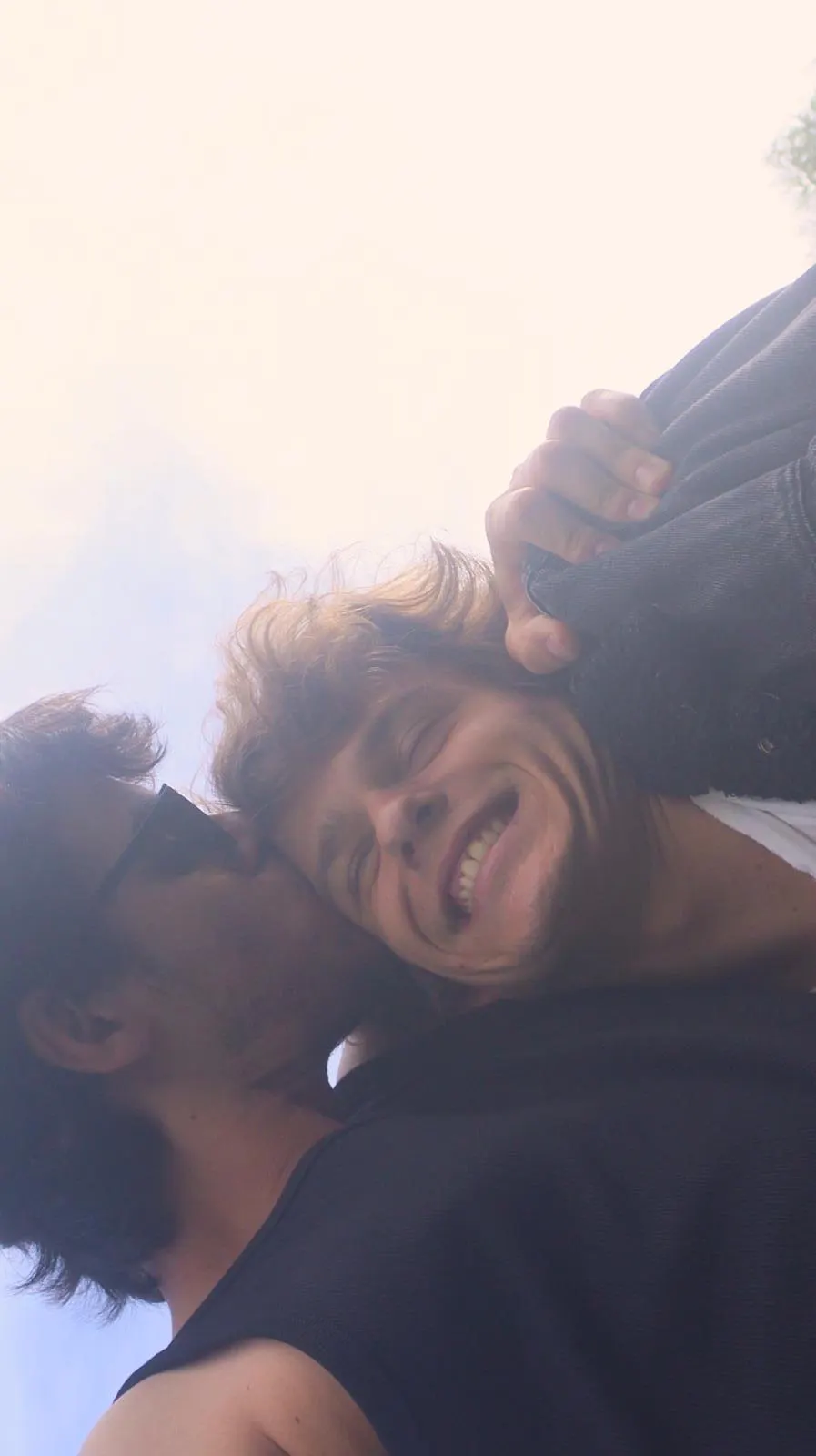 Two Sadhäna band members goofing around in bright sunlight