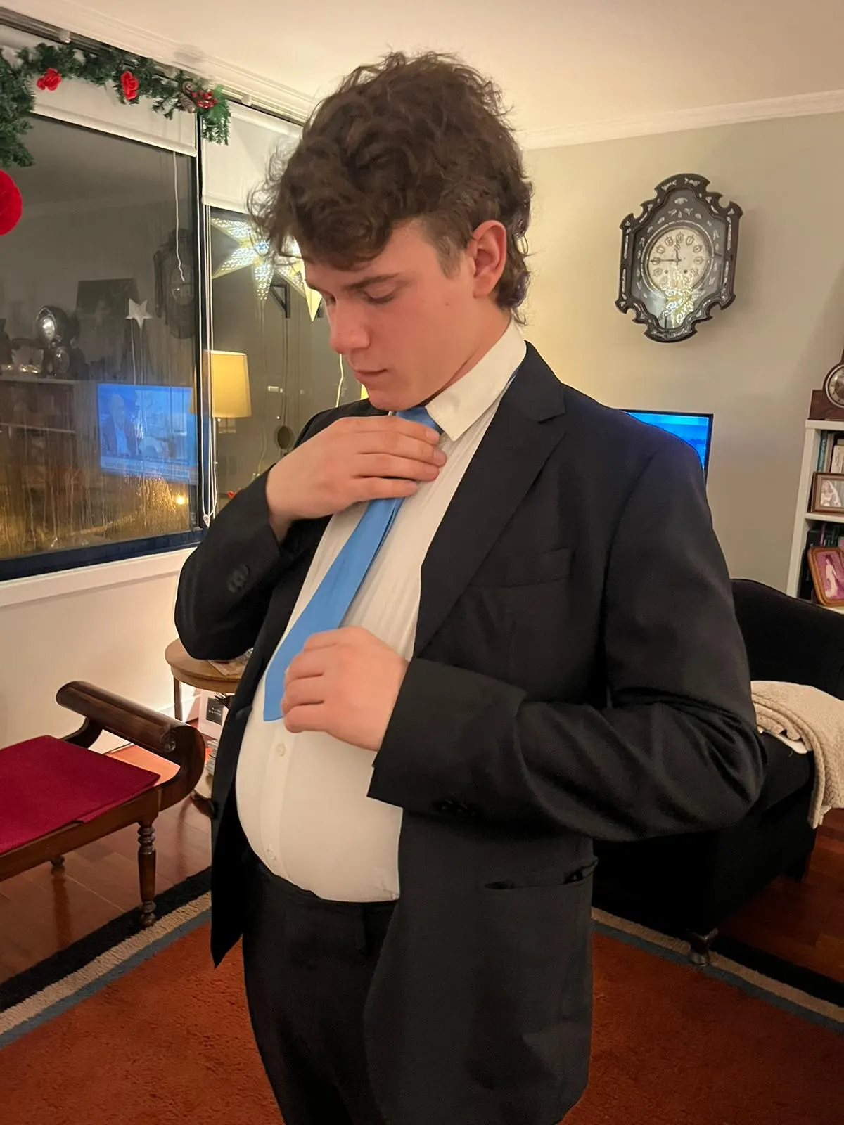 Sadhäna band member adjusting his tie while dressed up for a festive occasion